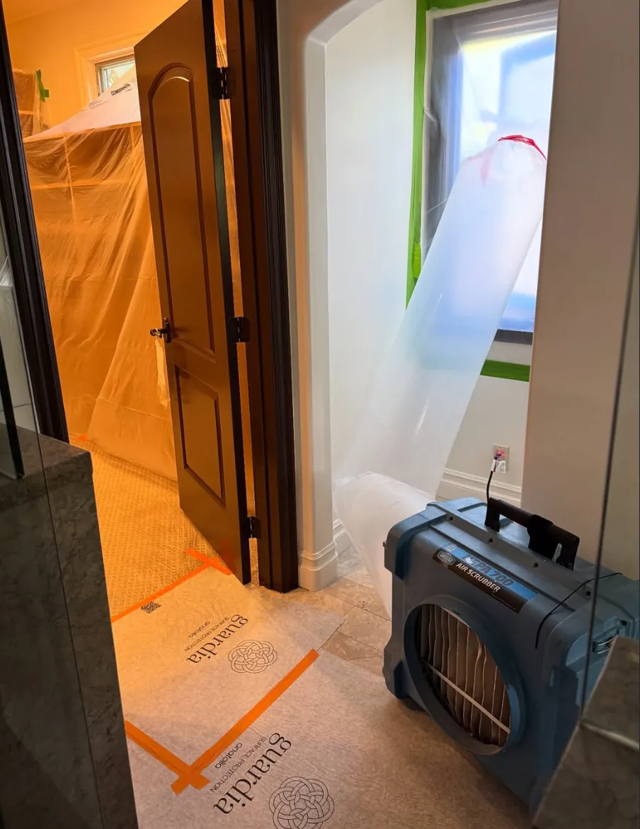 Revive Pro Solutions containment barrier and air scrubber set up on a mold remediation job