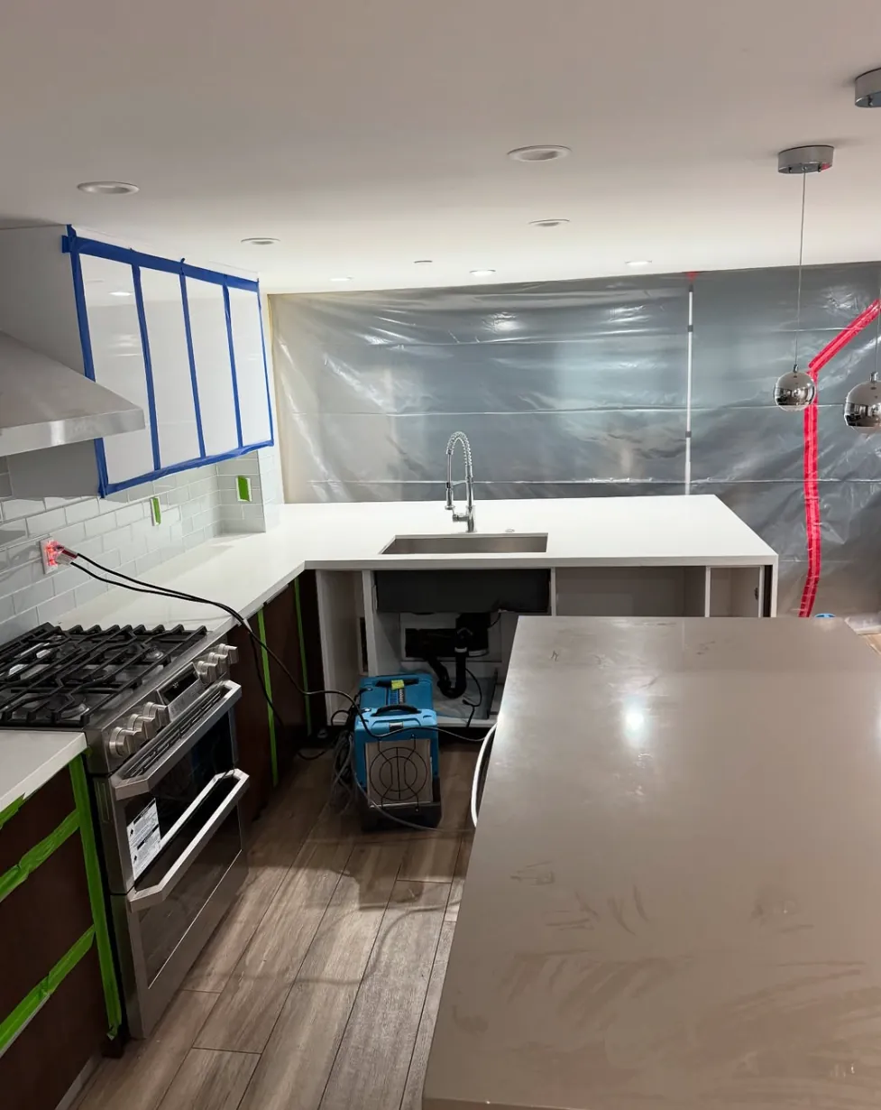 Kitchen cabinets and surfaces protected during a Revive Pro Solutions job
