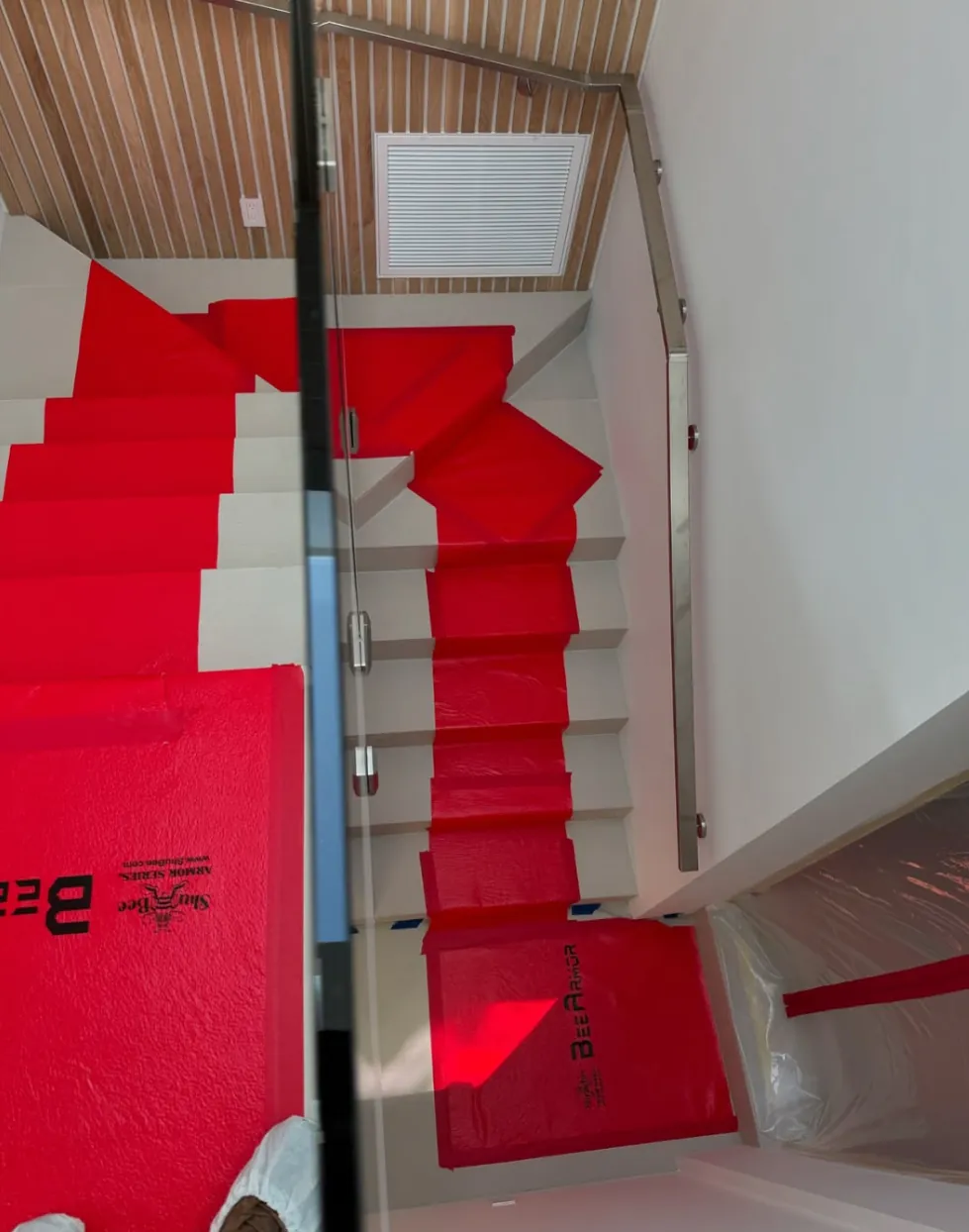 Stairs protected with surface covering during a Revive Pro Solutions job